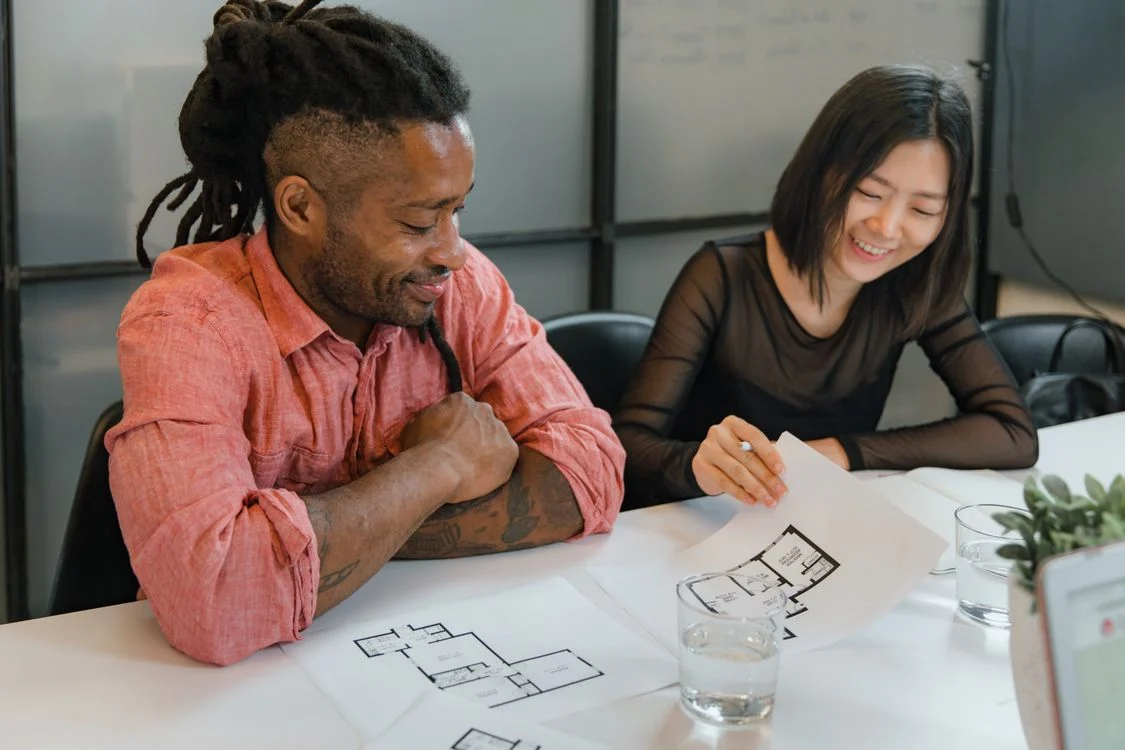 Colleagues collaborating on project plans at a table